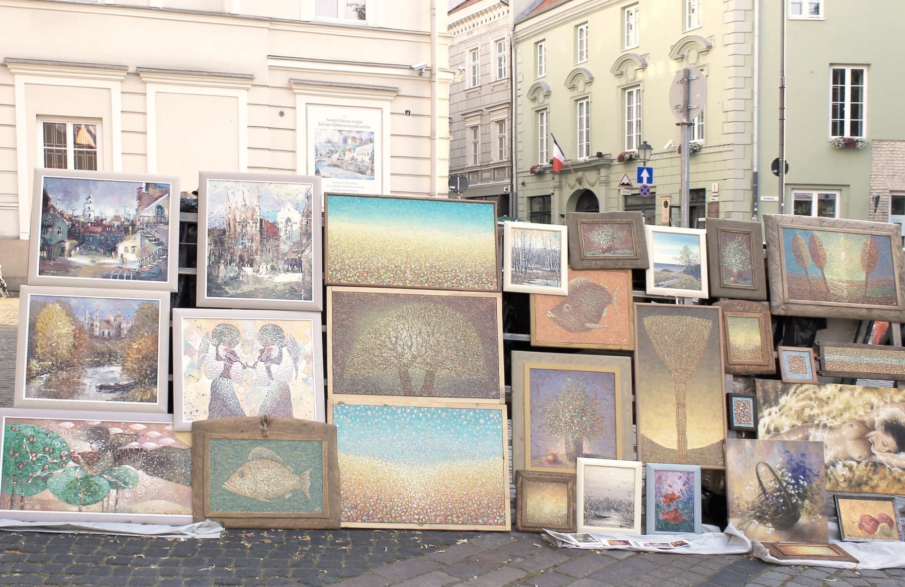 VILNIUS, LITHUANIA - JULY 18, 2015: Street artists sell paintings to the tourists on the street market in Old Town of Vilnius, Lithuania.