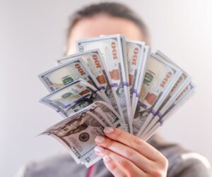 Why You Need To Start Your Flipping Business TODAY! person holding money