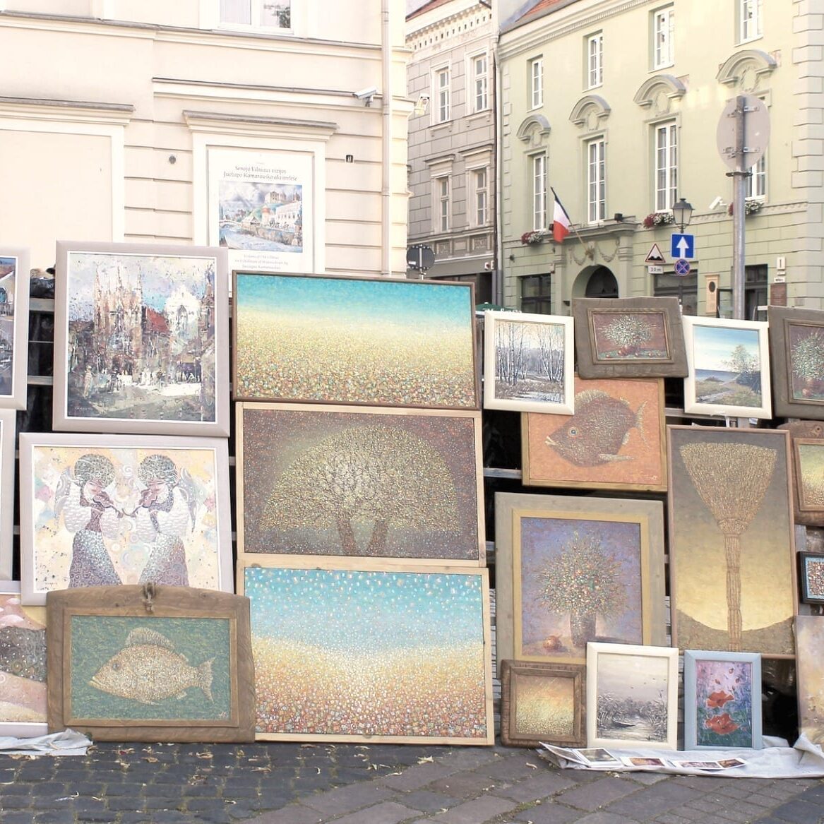 VILNIUS, LITHUANIA - JULY 18, 2015: Street artists sell paintings to the tourists on the street market in Old Town of Vilnius, Lithuania.